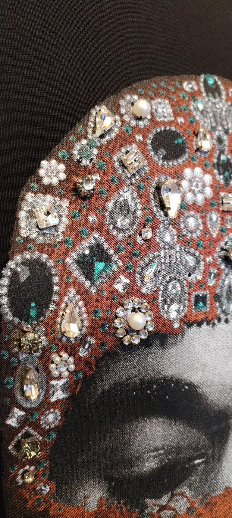 IH NOM UH NIT FW26 rust-brown cotton T-shirt with Mask Jewelry photographic print and applied crystals, decorative stones and pearl-like embellishments, front view.