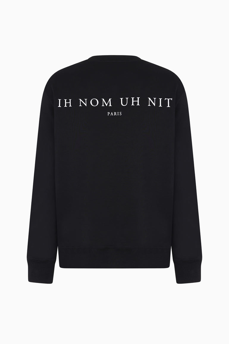 black crewneck sweatshirt with paisley mask print front and IH NOM UH NIT Paris logo back.
