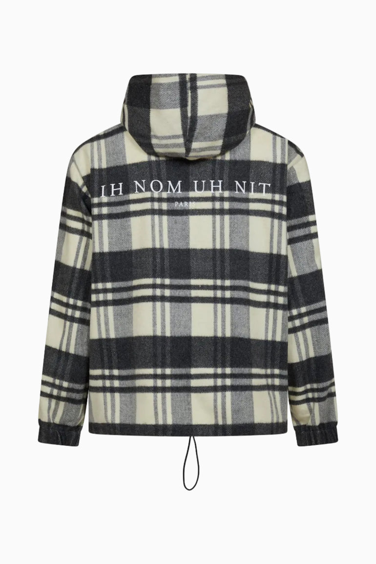 IH NOM UH NIT FW26 checked hooded anorak with white IH NOM UH NIT PARIS lettering across the upper back.