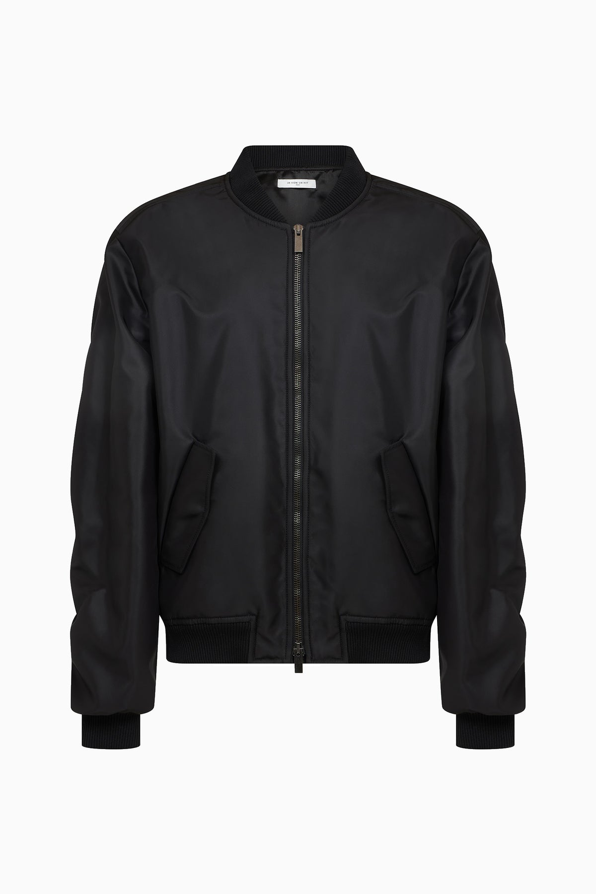 IH NOM UH NIT FW26 oversized black nylon bomber jacket with two-way zip and angled pockets, front view